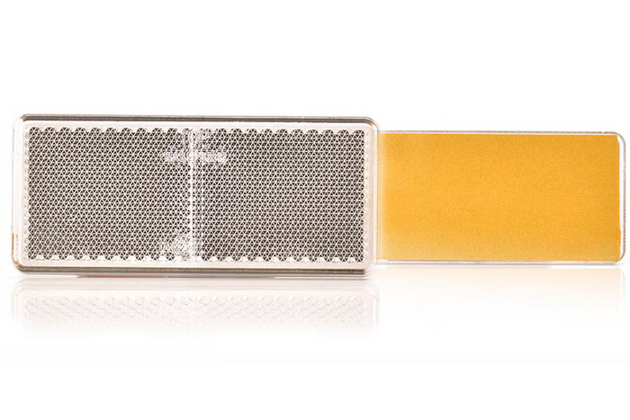 Dispositivo reflectante 96 x 42 mm, frontal con cinta adhesiva